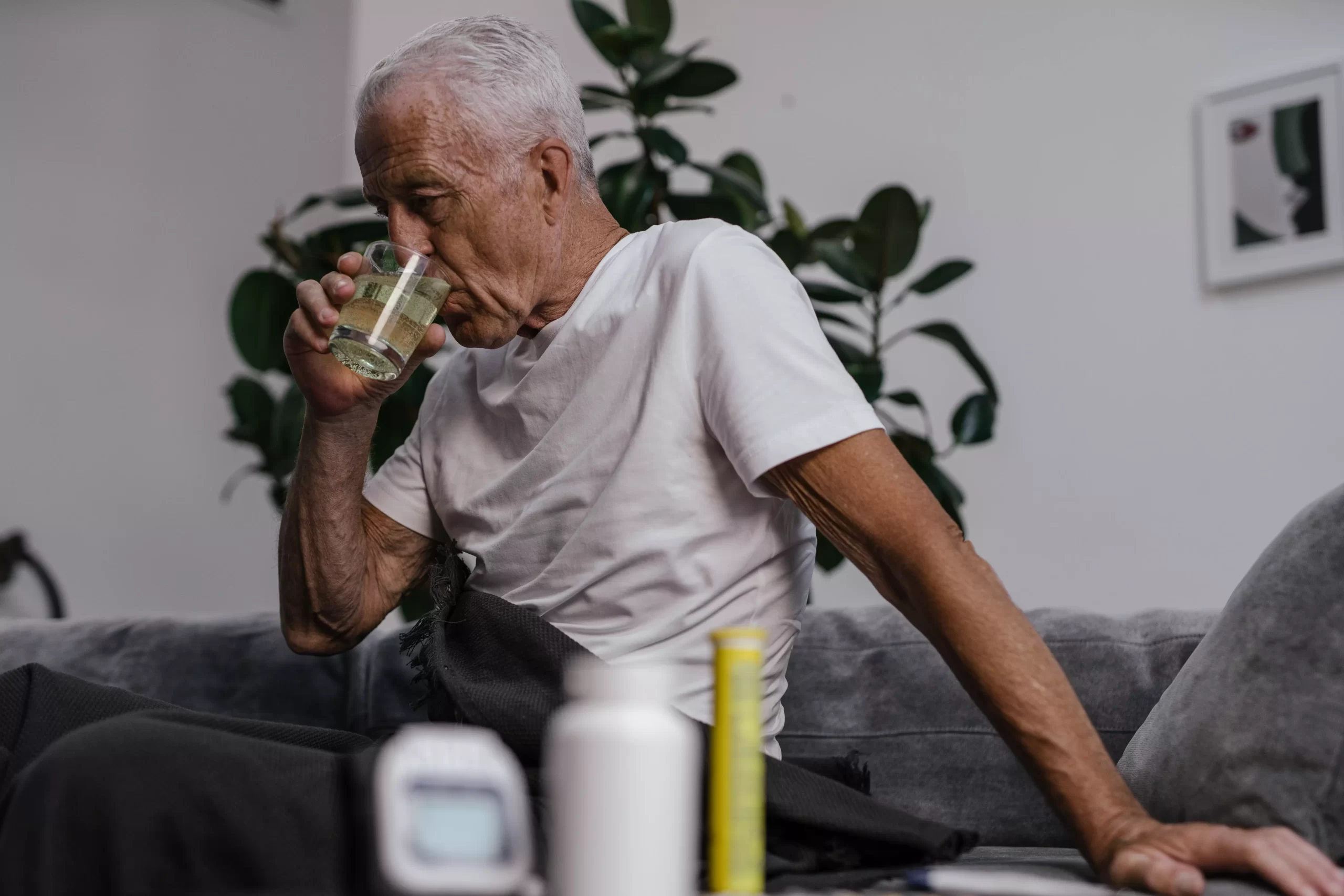 Elderly man drinking water during a Doctor Alert care call
